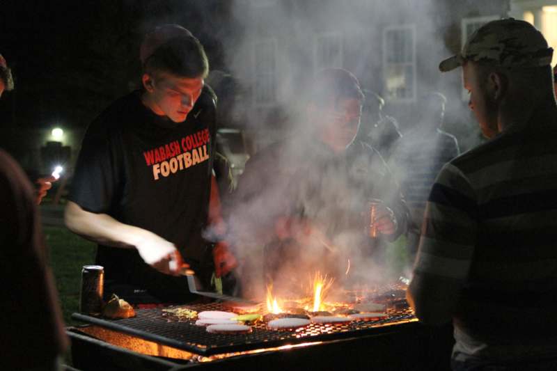 a group of men grilling food