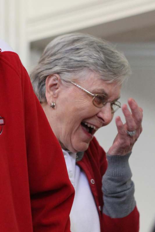 a woman laughing with her hand up