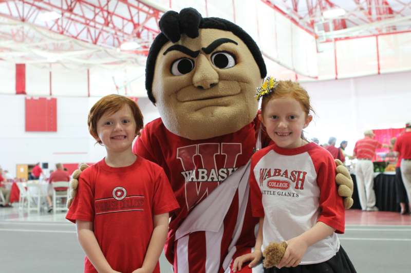 a group of kids posing with a mascot
