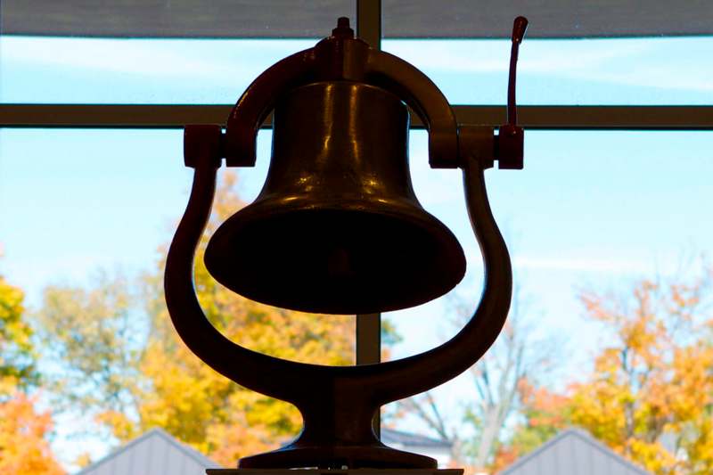a bell in front of a window