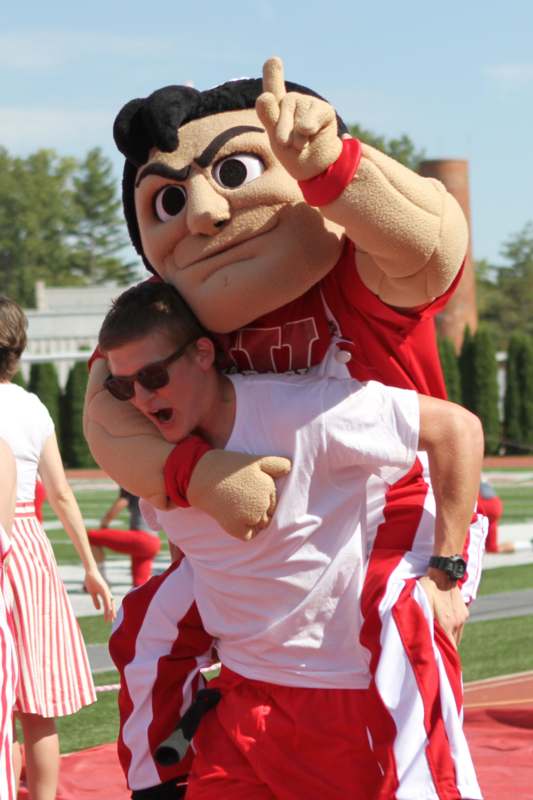 a man carrying a person in a mascot garment