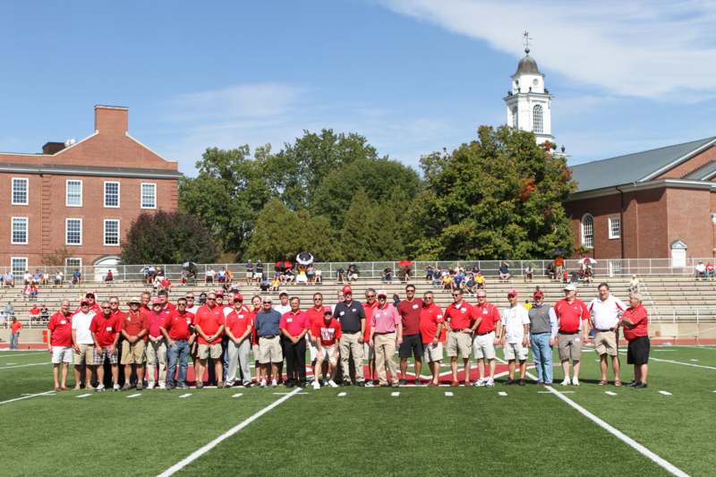 a group of people standing on a football field