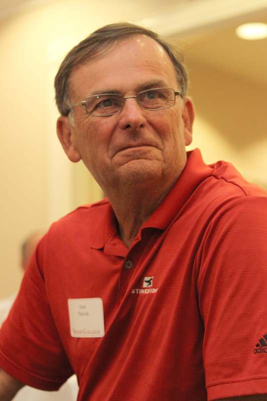 a man wearing glasses and a red shirt