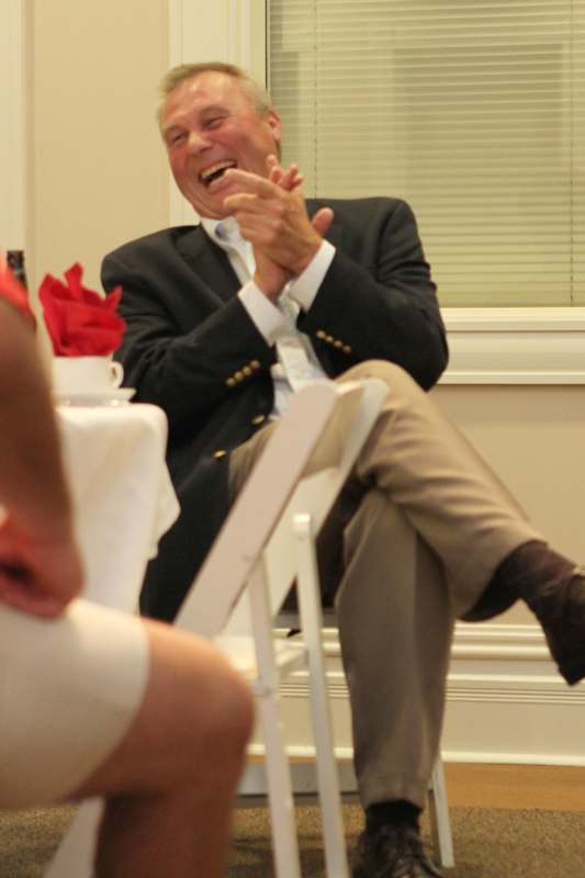 a man sitting in a chair laughing