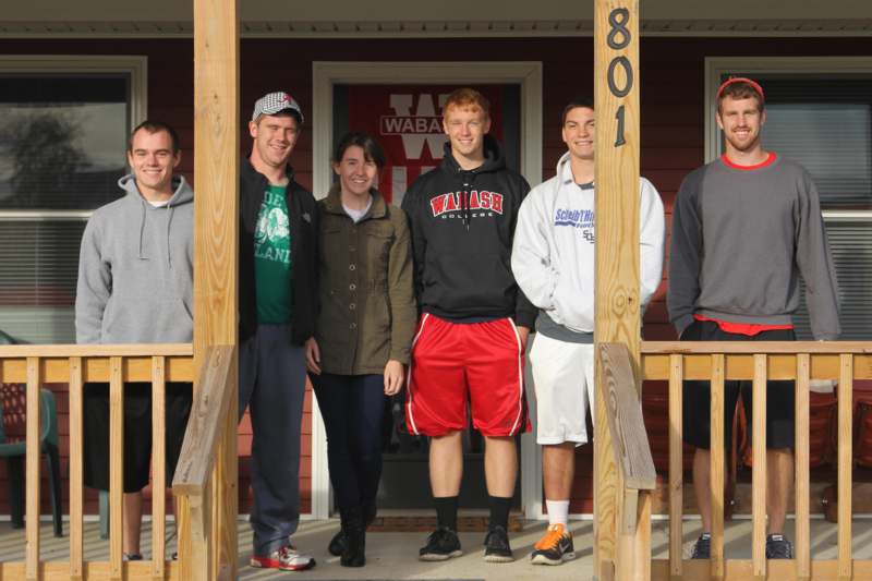 a group of people standing on a porch