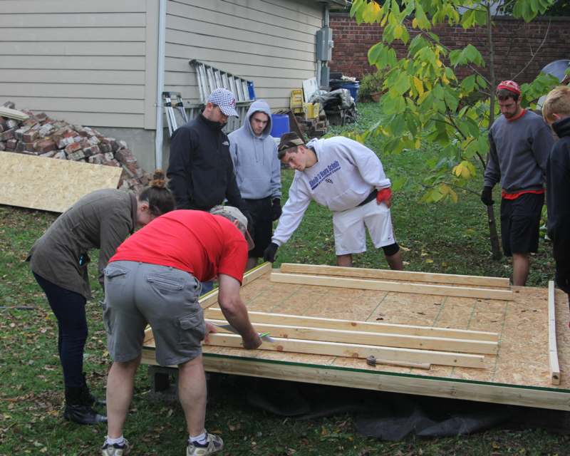 a group of people building a house
