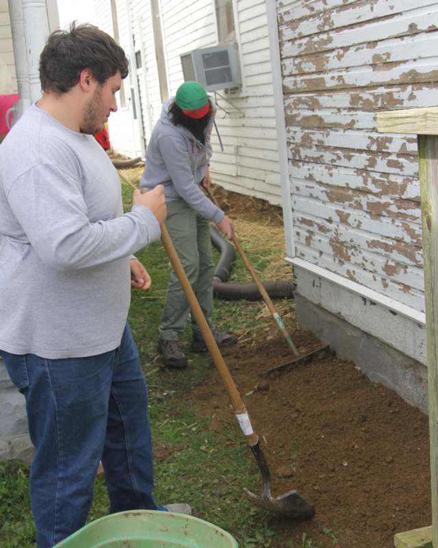 a man and woman digging in dirt