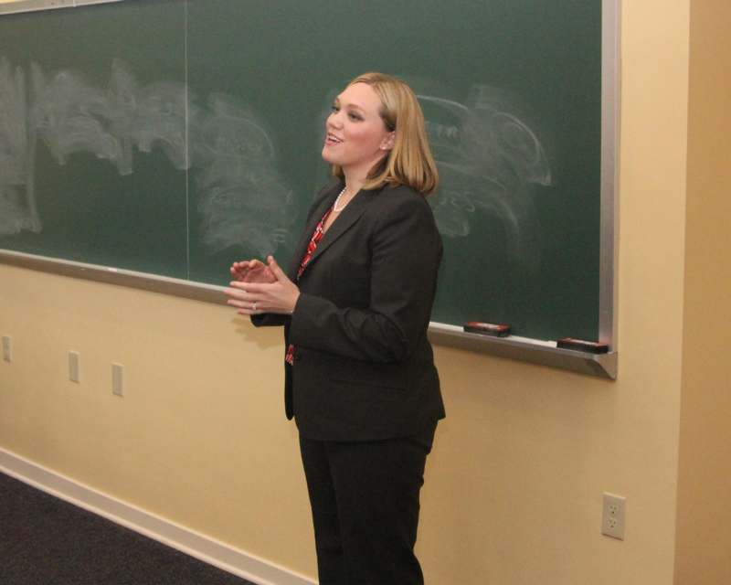 a woman standing in front of a chalkboard