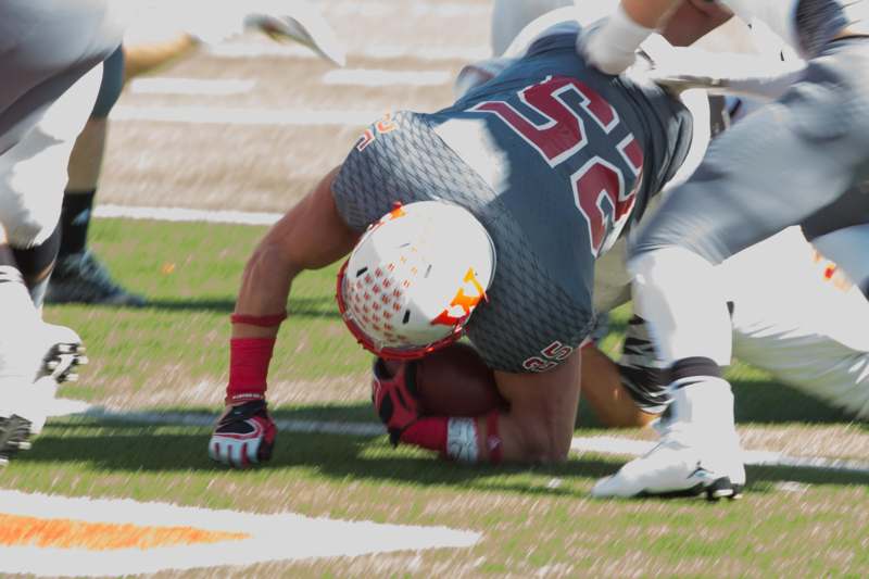a football player falling down on the ground