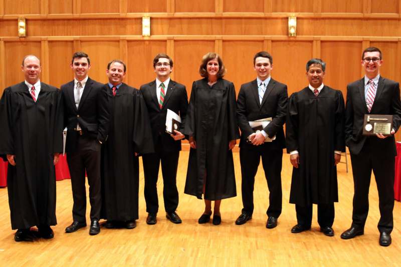 a group of people wearing black robes