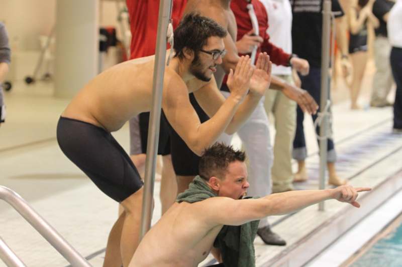 a group of men in swim trunks