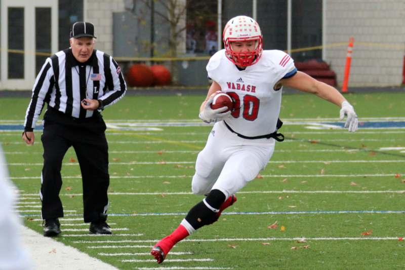 a football player running with a football in his hand