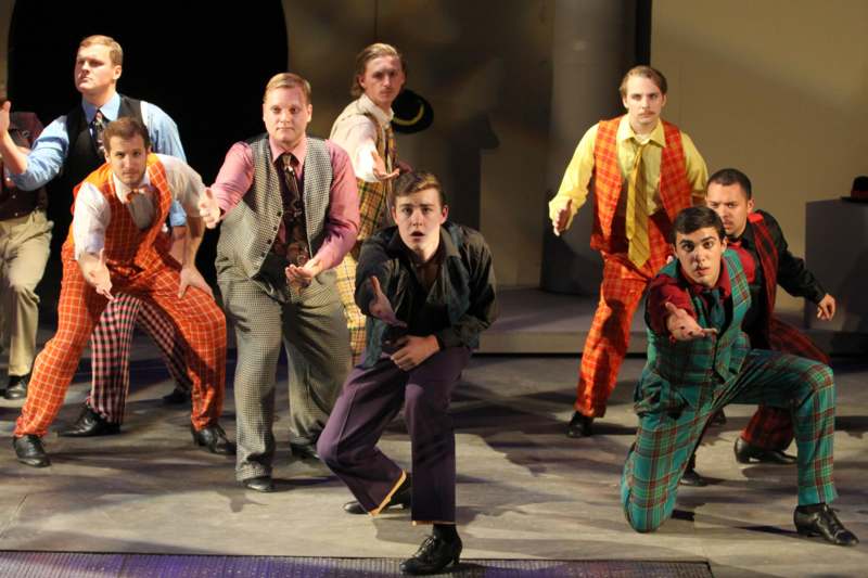 a group of men dancing on a stage