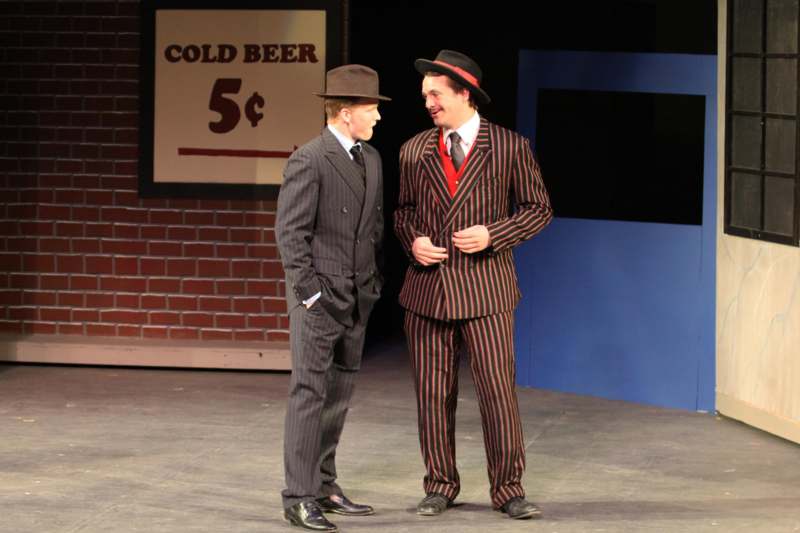 two men in suits on a stage