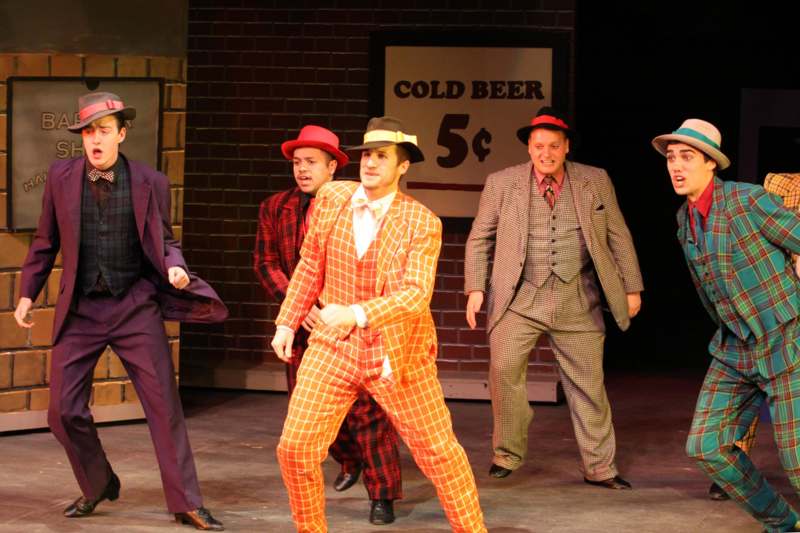 a group of men in suits on a stage