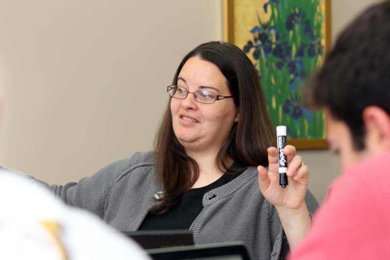 a woman holding a marker