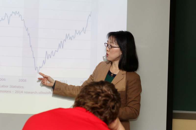 a woman pointing at a graph