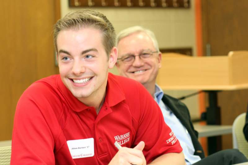 a man in a red shirt smiling