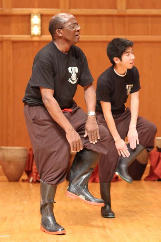 a man and boy wearing black shirts and boots