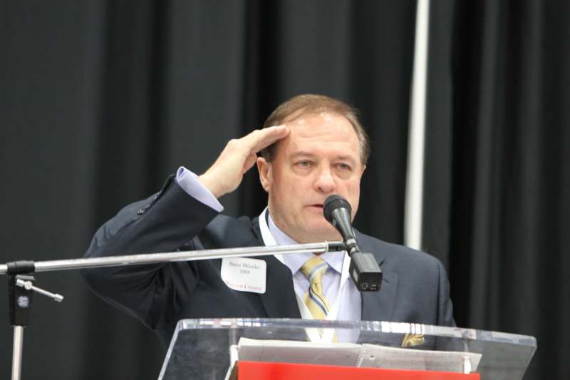 a man saluting at a podium
