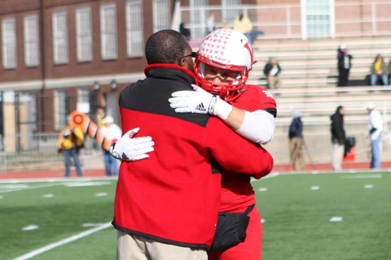 a football player hugging another football player