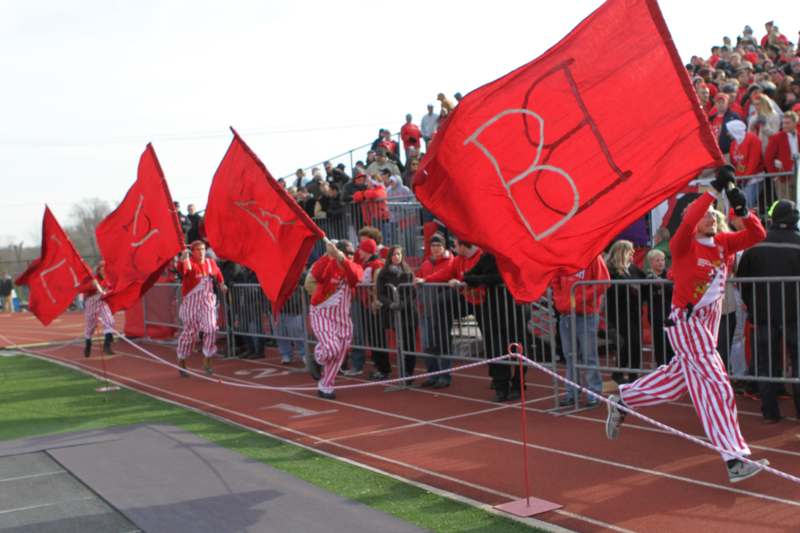 a group of people holding flags on a track