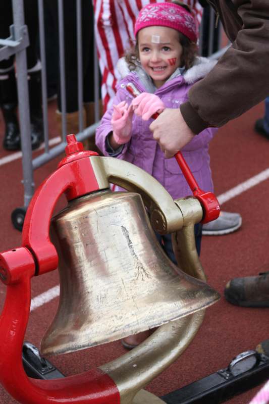 a child holding a bell