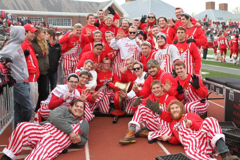 a group of people in red and white striped outfits