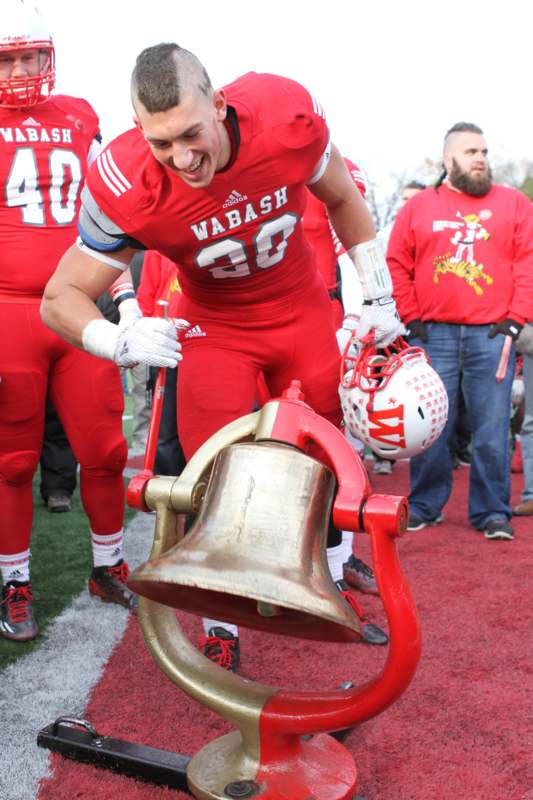 a football player holding a bell