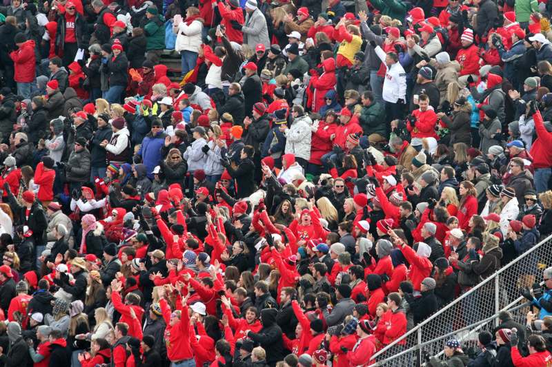 a crowd of people in red and black