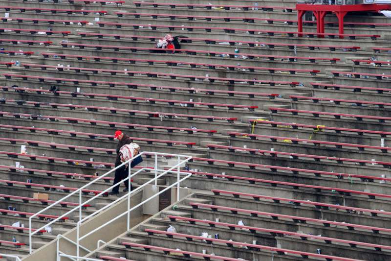 a man walking down the stairs of a stadium
