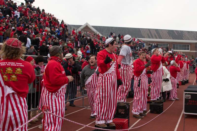 a group of people in striped red and white outfits