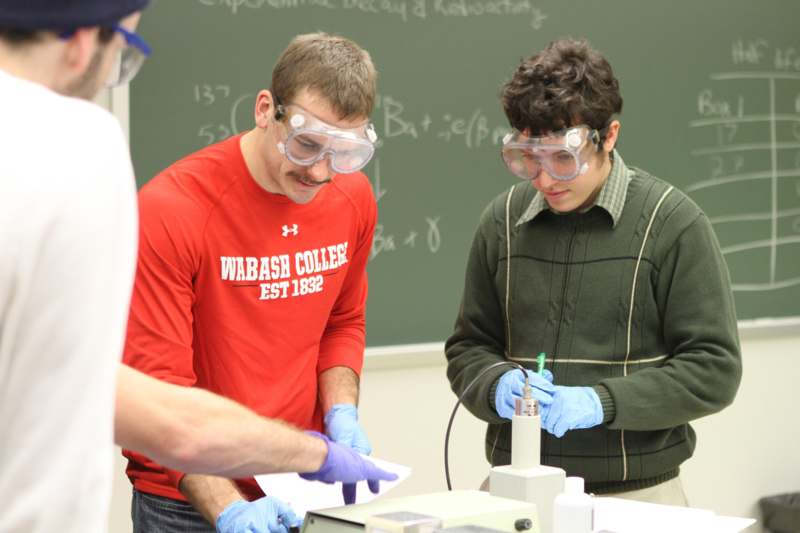 a group of people wearing safety goggles and gloves