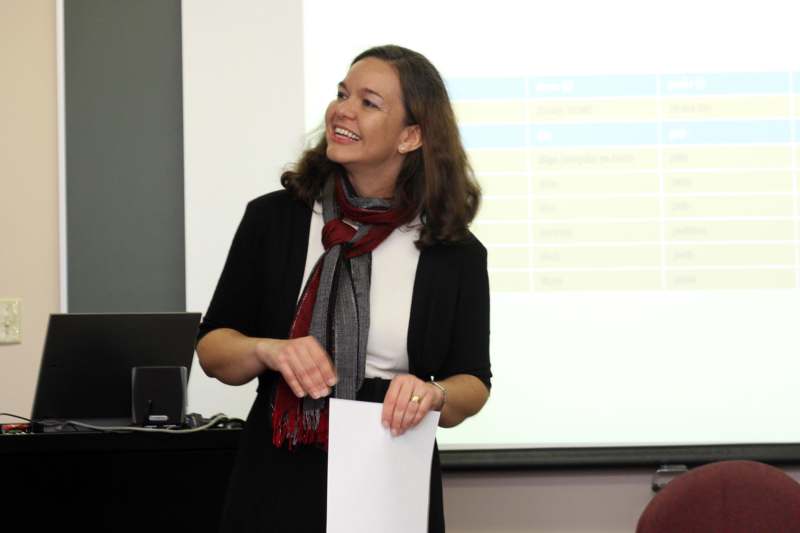 a woman smiling at a presentation