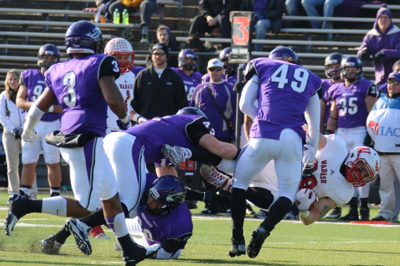 a group of football players in purple uniforms