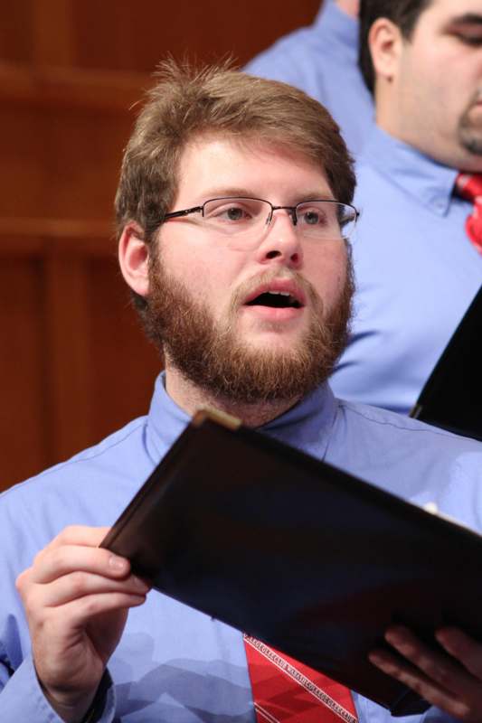 a man with a beard holding a folder