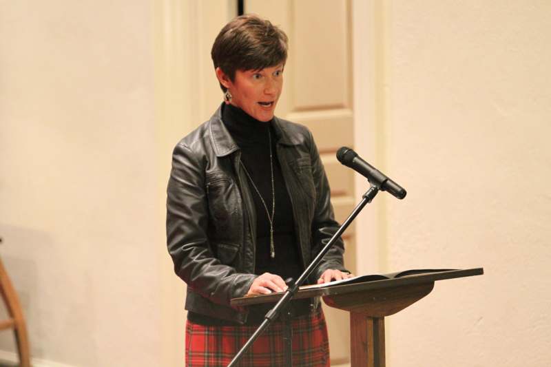 a woman standing at a podium with a microphone