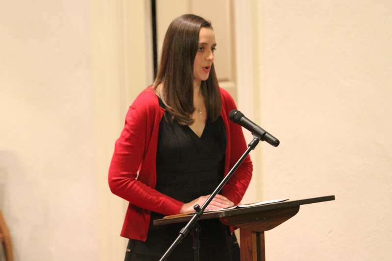 a woman standing at a podium with a microphone