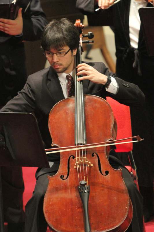 a man playing a cello