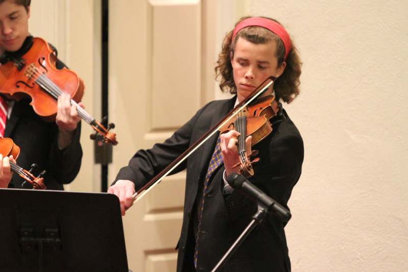 a man playing violin and a woman playing violin