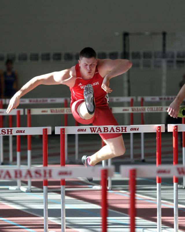 a man jumping over hurdles