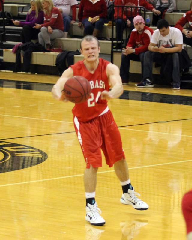 a man in red uniform dribbling a basketball