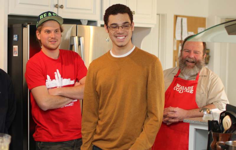a group of men standing in a kitchen