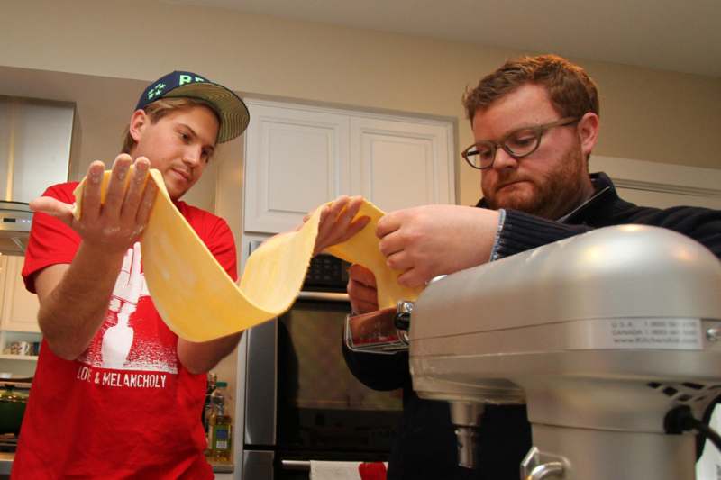 a man and a man making pasta