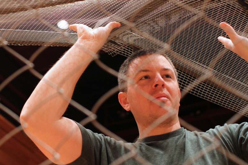 a man holding a metal mesh