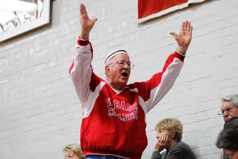 a man in a red shirt with his hands up