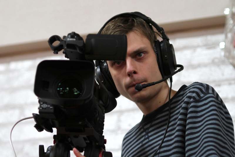a man with headphones holding a camera
