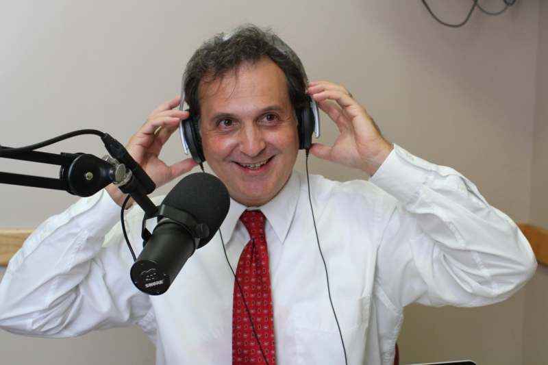 a man wearing headphones and holding a microphone