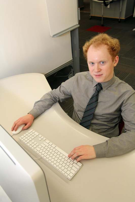 a man sitting at a desk with a keyboard