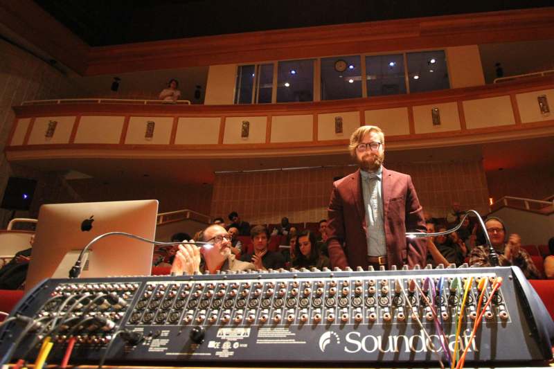 a man standing in front of a sound board